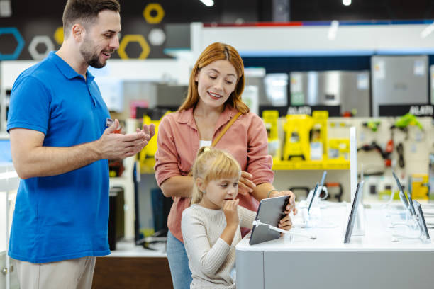istock Mother and daughter exploring electronic gadgets in a tech store 2182894470