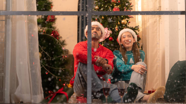 istock Couples relax, drink and celebrate on a snowy Christmas night 2182896644