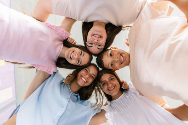 istock Portrait of smiling school kids standing together in circle at elementary class 2182898913