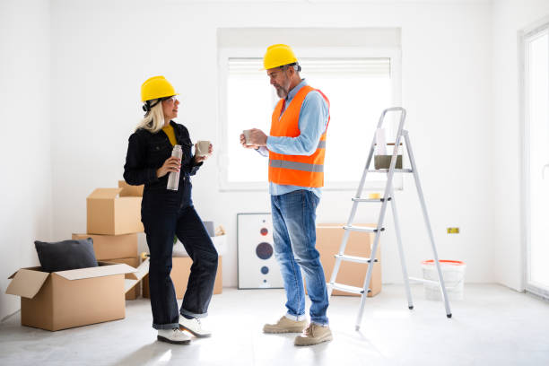 istock Couple drinking coffee and resting while renovating new apartment 2182900356