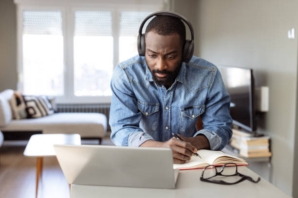istock Focused man listening to online course on a laptop 2182900603