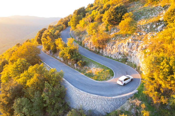 istock Car traveling hairpin bend on mountain road 2182901700