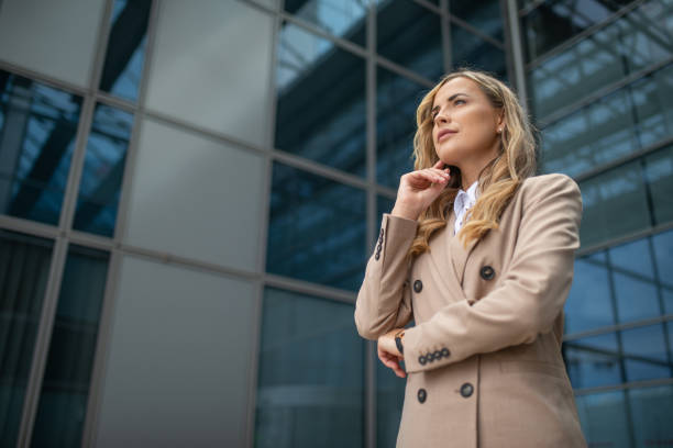 istock Businesswoman planning strategy while standing near office building 2182903367