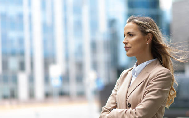 istock Businesswoman looking ahead in a modern city setting 2182904660