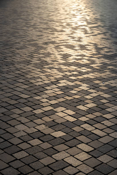 istock gray paved road from concrete pavers 2182905140