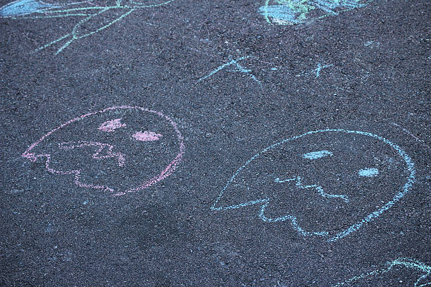 istock Chalk drawings of sad ghost on the asphalt 2182911056