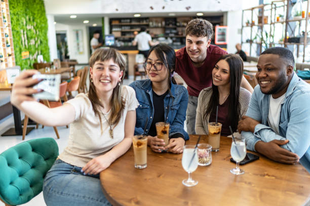 istock Young diversity friends taking selfie in a coffee shop 2182911167