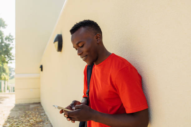 istock Connected Youth: Man in Red Shirt Using Smartphone 2182915132