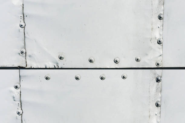Grunge metal sheet. Rusty metal pattern. Row of nails. Screws line. Steel pattern. Empty copy space. Instrudial wall background. Workshop gray paint. Solid construction. Factory backdrop.