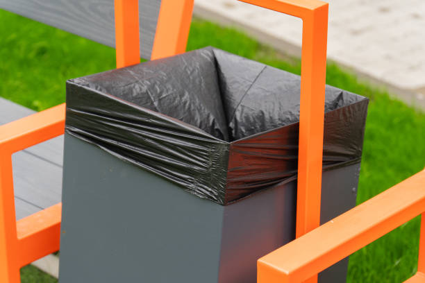 istock A contemporary trash bin features an elegant black liner, seamlessly integrated with orange seating in a lush green park, inviting visitors to enjoy the fresh air 2182920263