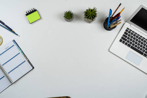istock Top view of office workplace desk with laptop pen on notebook 2182921448
