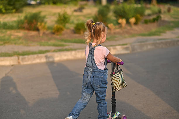 istock A little girl riding a scooter 2182922630