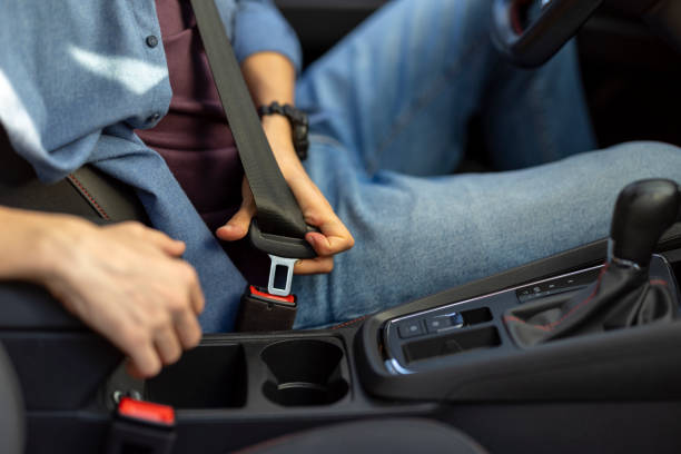 istock Young man wearing his seat belt while driving 2182924406