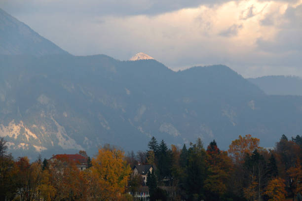 Traditional architecture and beautiful autumn foliage on the coast of Lake Bled, Slovenia.
