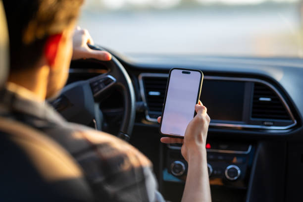 istock A young man traveling by car makes contactless payments with his smartphone without getting out of the vehicle. 2182924627