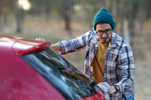 istock Handsome young man is washing his car 2182924649