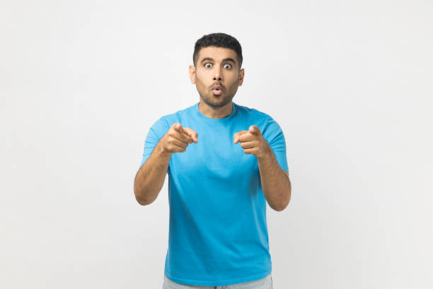 istock Excited amazed astonished man standing pointing index fingers to camera, expressing astonishment. 2182926025