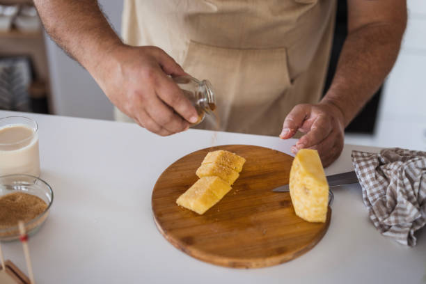 istock Chef pouring brown sugar on sliced pineapple 2182926400