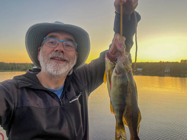 istock Proud mature man showing fish catch 2182931145