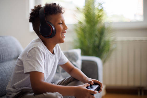 istock Young boy playing video games at home 2182931698
