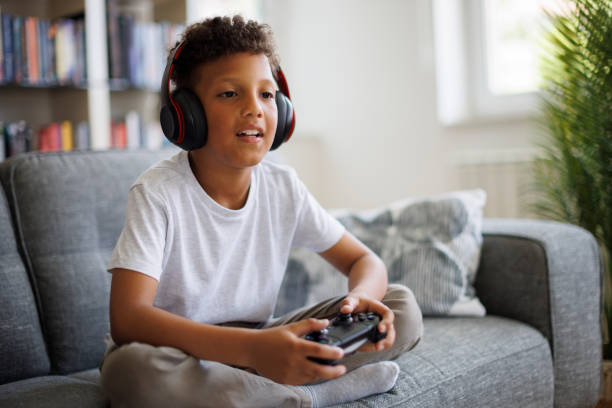 istock Young boy playing video games at home 2182931699