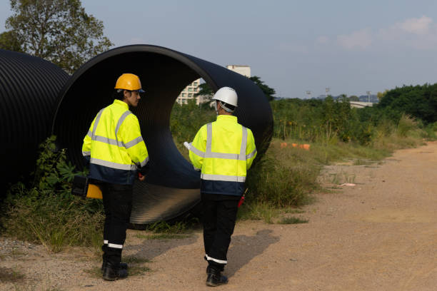 istock Two male Project engineers walked together to survey the area designated for drilling drainage pipes in the construction of new roads near the community and residential areas. 2182936064