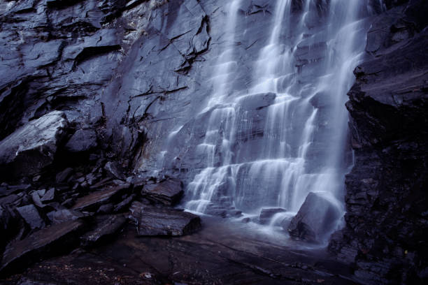 Misty, cool water flows down jagged rock face in North Carolina