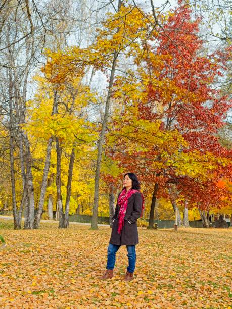 istock Woman enjoying the fall foliage in a park. 2182937839