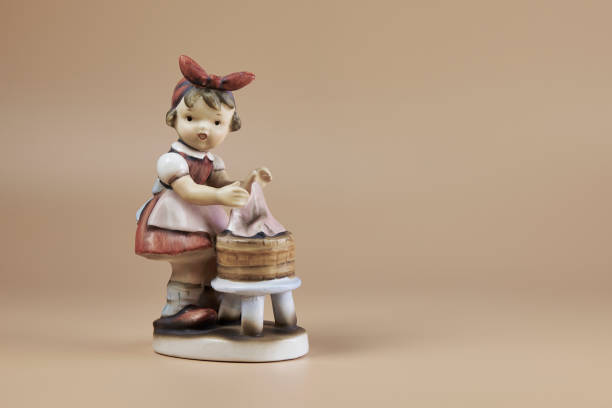 istock antique doll washing clothes by hand without washing machine 2182941619