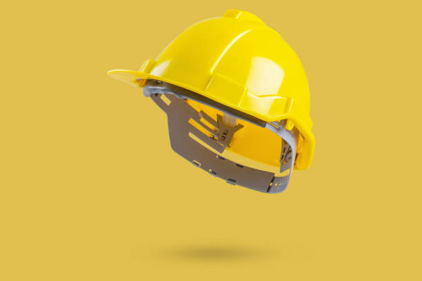 istock Safety construction helmet on yellow background 2182942201