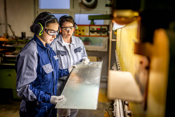 istock Professional Female Workers Operating Industrial Press Brake 2182942853