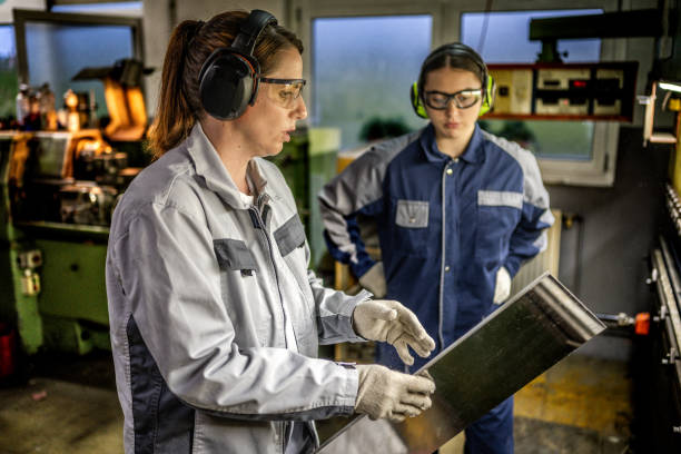 istock Industrial Precision: Caucasian Women Operating Press Brake 2182942855