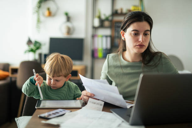 istock Single mother calculating family budget. 2182944369
