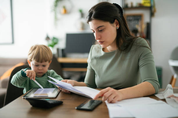 istock Single mother calculating family budget. 2182944382