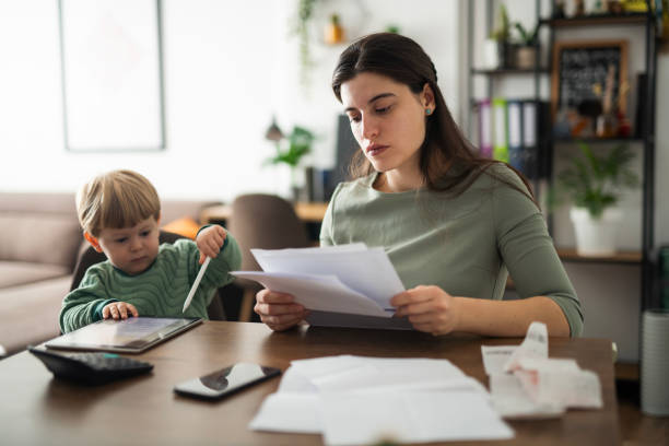istock Single parent managing finances at home. 2182944384