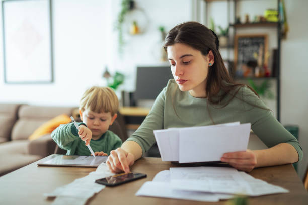 istock Single mother calculating family budget. 2182944407
