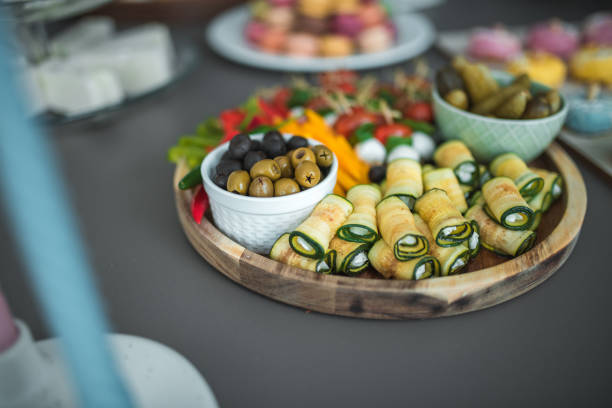 An inviting baby shower table boasts personalized pastries, colorful macarons, and a selection of savory appetizers for the guests.