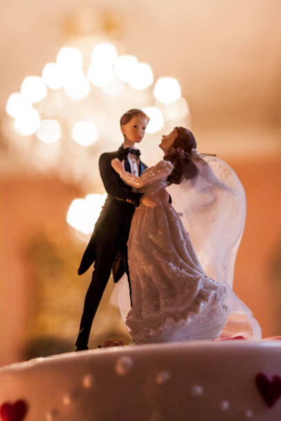 istock A beautifully decorated wedding cake with a couple figurine in an elegant setting 2182967943