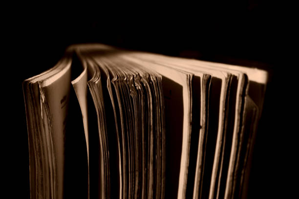 istock A thick old book standing in a low light place 2182968063