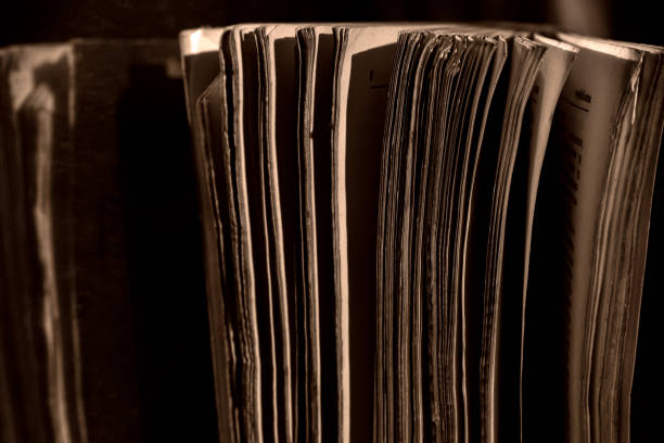 istock A thick old book standing in a low light place 2182968093
