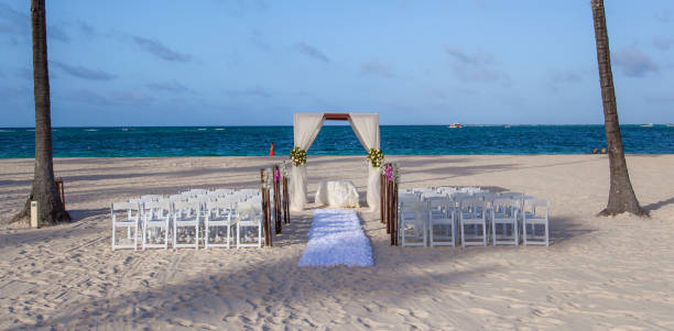 istock Beautiful beach wedding ceremony set up with chairs and decor by the ocean at sunset 2182968295