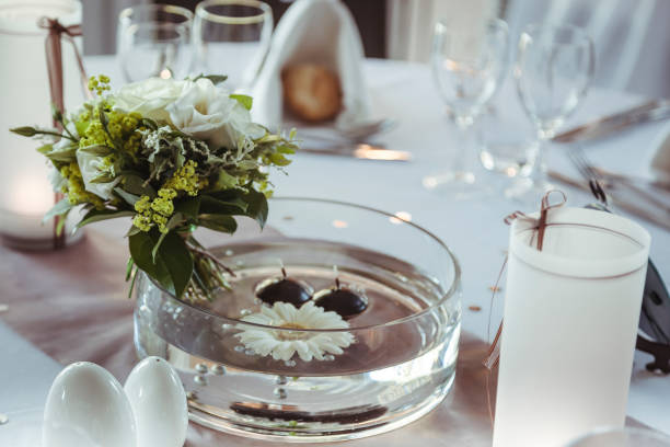 istock Elegant table setting featuring floral centerpiece and candlelight at a wedding reception 2182969493