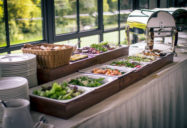 istock Elegant buffet setup featuring fresh salads and assorted dishes in a bright venue 2182969518