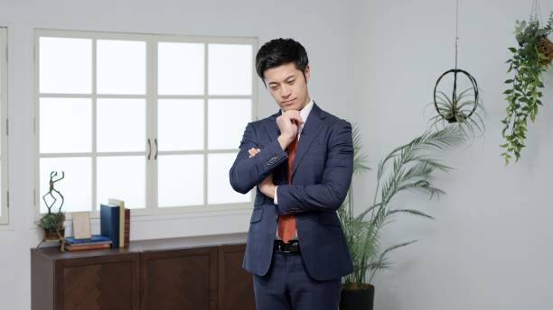 istock Asian businessman thinking with his arms folded 2182969961
