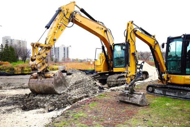 istock yellow excavators on construction site excavator bucket close up 2182970125