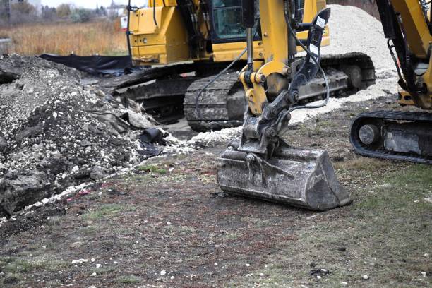 istock yellow excavators on construction site excavator bucket close up 2182970128