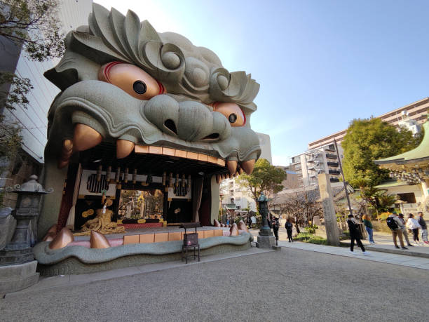Tourists sightseeing the famous lion head in Nanba Shrine, a Shinto Shrine in Osaka, Japan