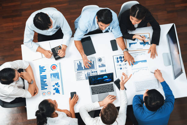 istock Analyst team utilizing BI Fintech to analyze financial data at table. Prudent 2182971638