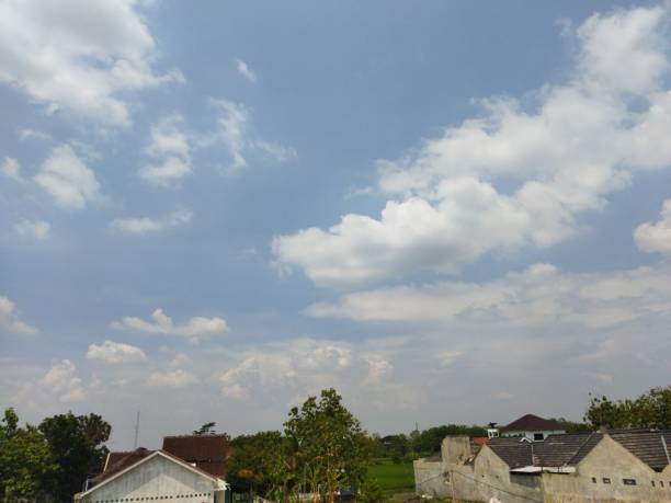 istock blue cloudy sky above the village 2182977097
