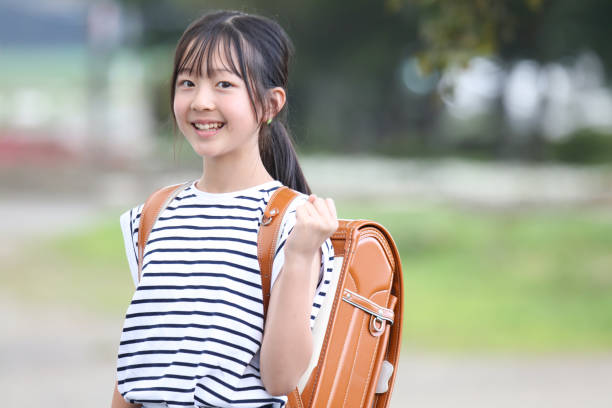 istock A girl carrying a school bag 2182977505